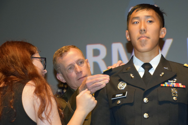 2nd Lt. Trinh receiving his gold bar from his wife and Maj. Gen. Curtis Buzzard
