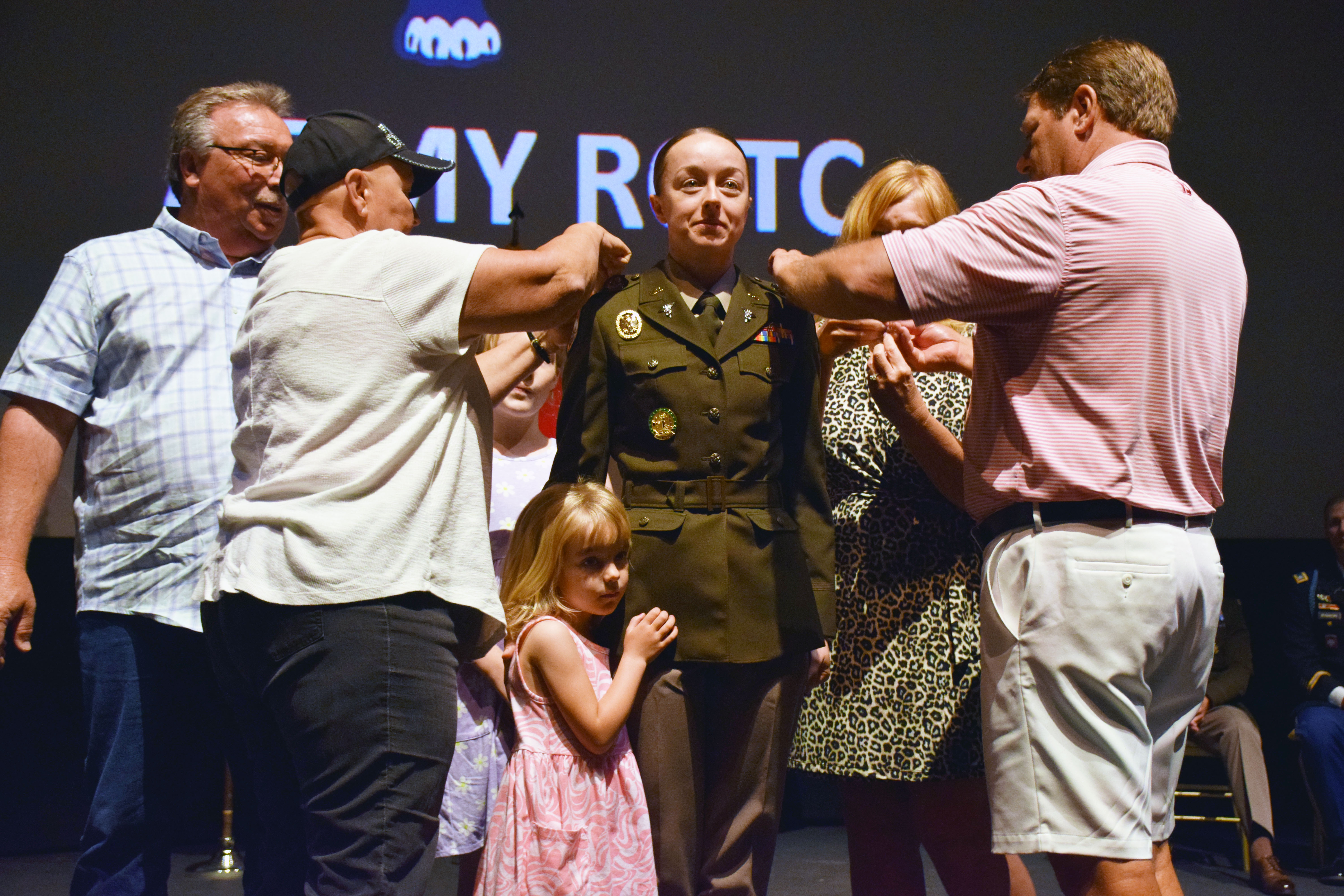 2nd Lt. Cortney Moore is pinned by her family.