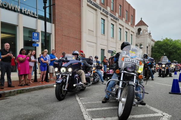 Miracle Riders depart Frank Brown Hall on their motorcycles on May 22