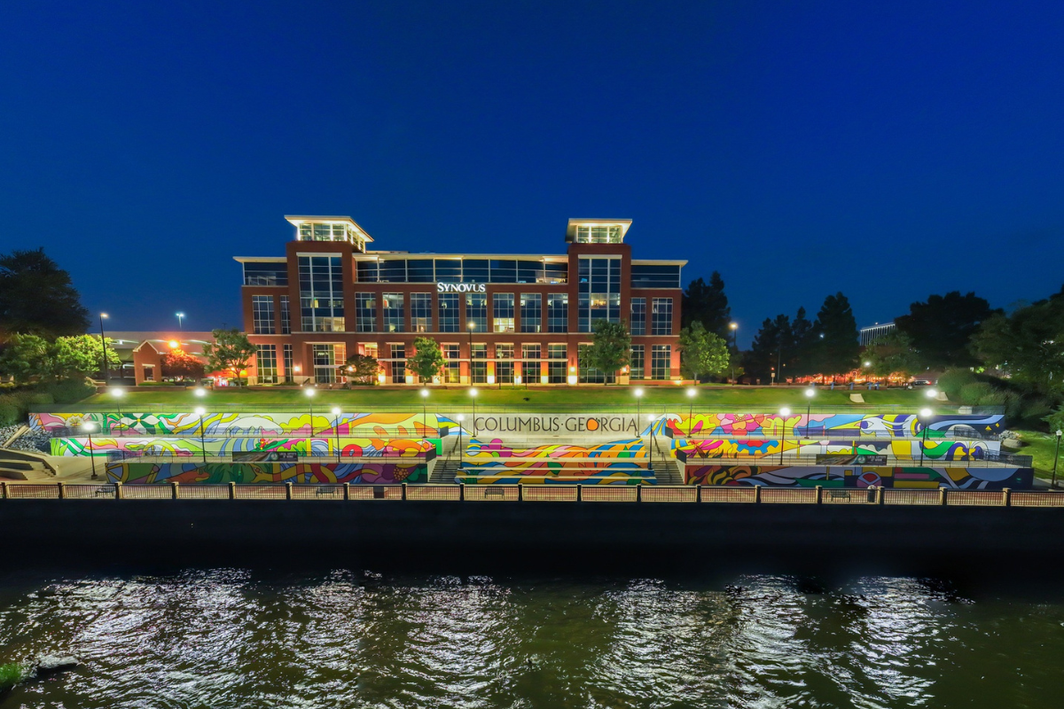 Nighttime image of The Spririt of the Chattahoochee along the river banks at the base of the Synovus building