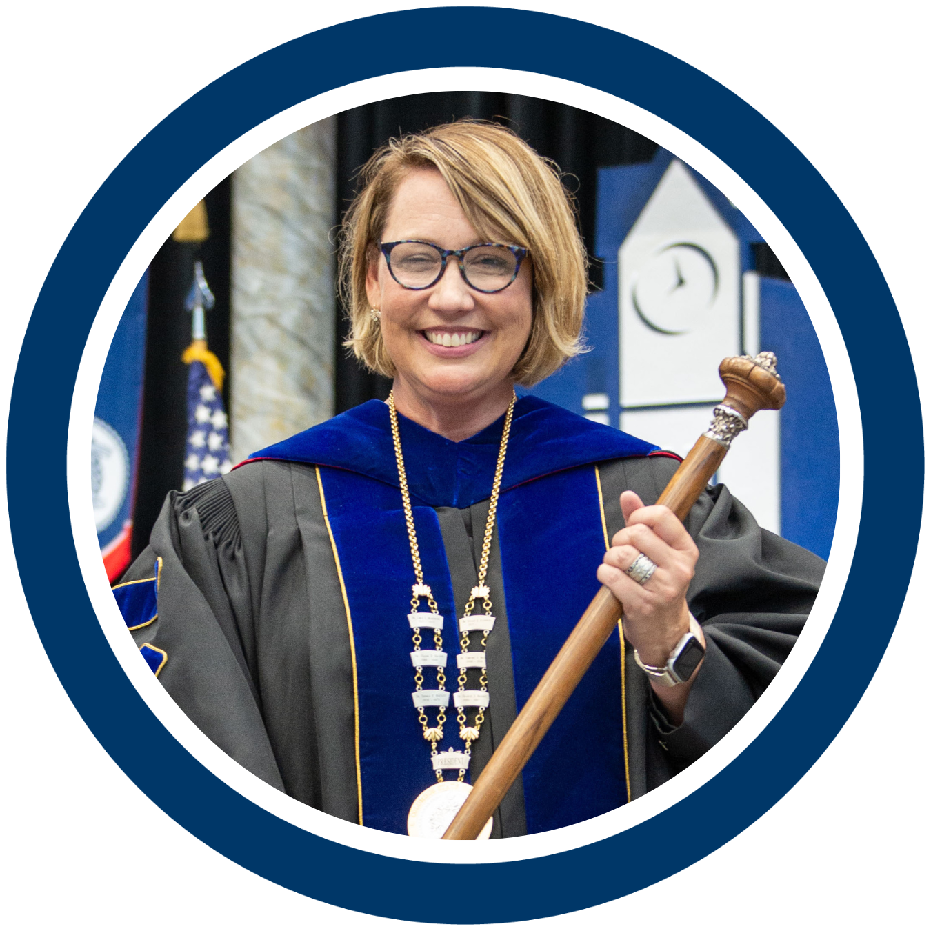 Picture of Dr. Rayfield in her academic regalia wearing the presidential medallion and holding the university mace