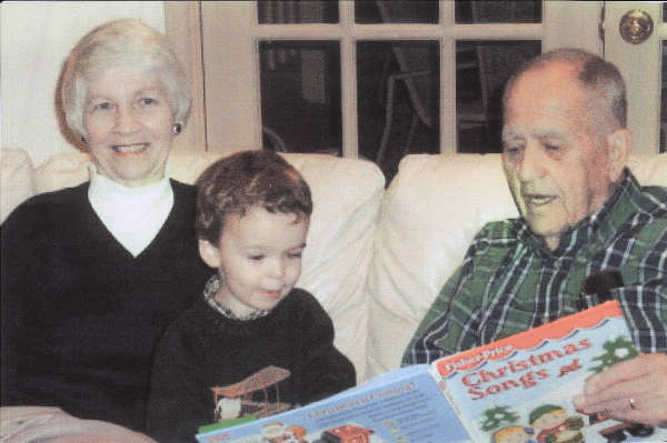 Norma and George Roberts reading to their grandson Winston