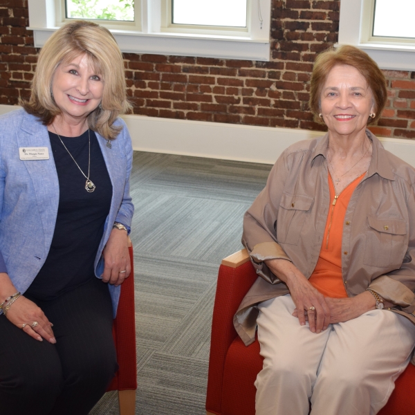 Margie Yates and Ellen Roberts seated and posing for a picture