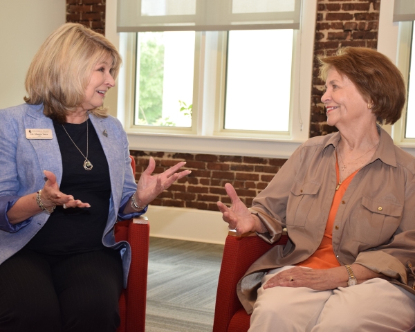 Margie Yates and Ellen Roberts seated and having a conversation