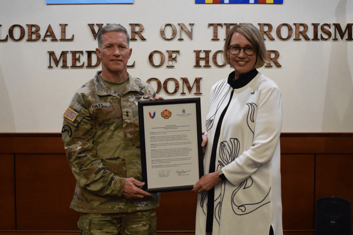 MG Tuley and President Rayfield hold up a signed agreement.