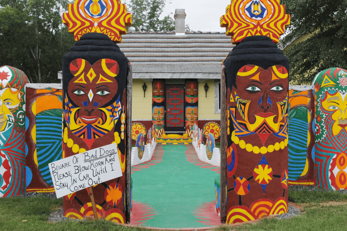 Painted totems that form an entrance to the Pasaquan community