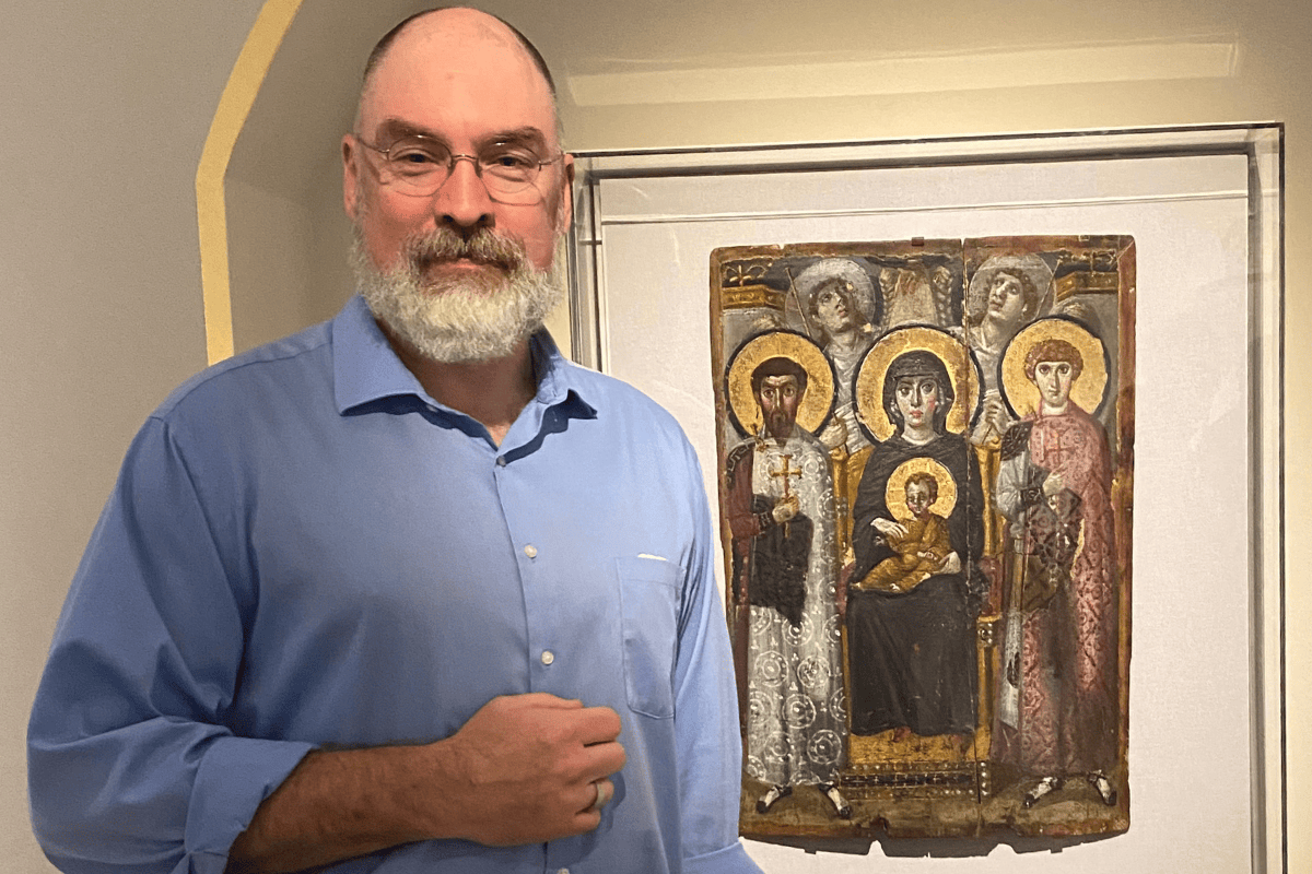 Kline pictured with "Icon with the Virgin and Child, Saints, Angels, and the Hand of God"