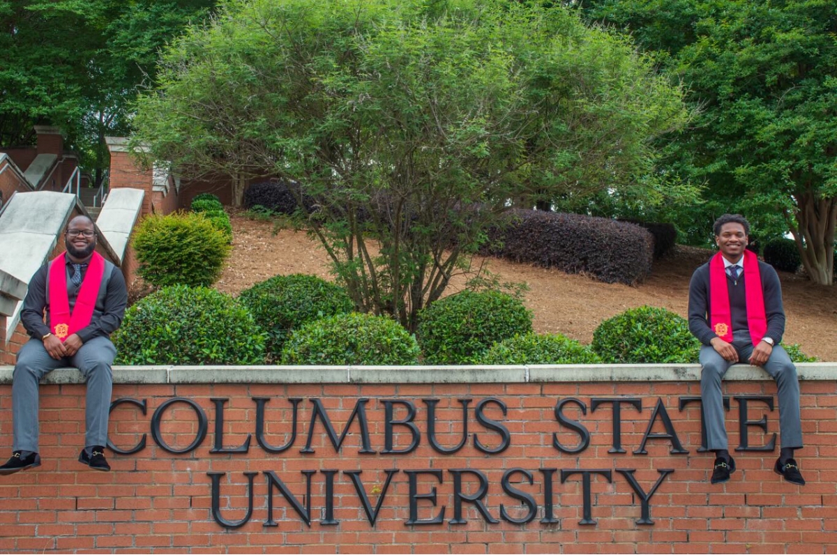 Micah (left) and Nicholes (right) on the Columbus State University wall