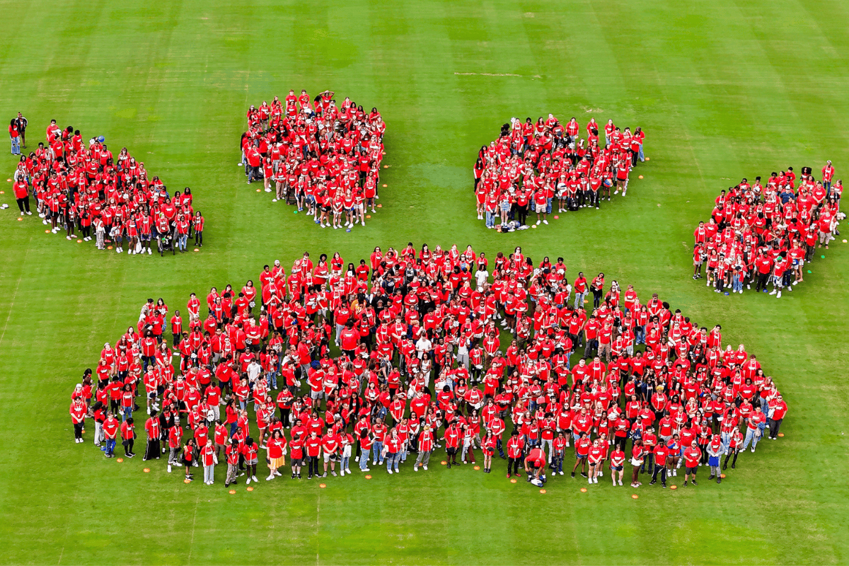 Nearly 900 first-time students and members of the Class of 2029 show their school spirit by posing for a paw-shaped class photo on the Ragsdale Field outfield.