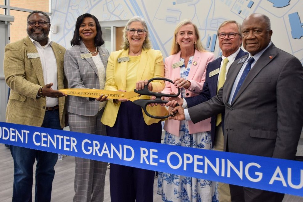 Six elected officials gather to cut the ceremonial ribbon during the Davidson Student Center grand re-opening ceremony.