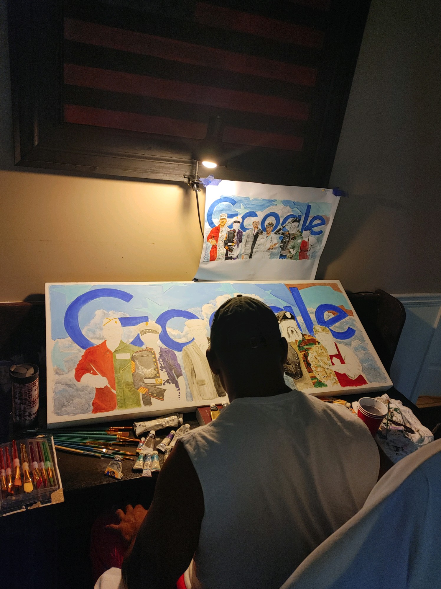 Steve Tette sits at the Google doodle canvas painting.