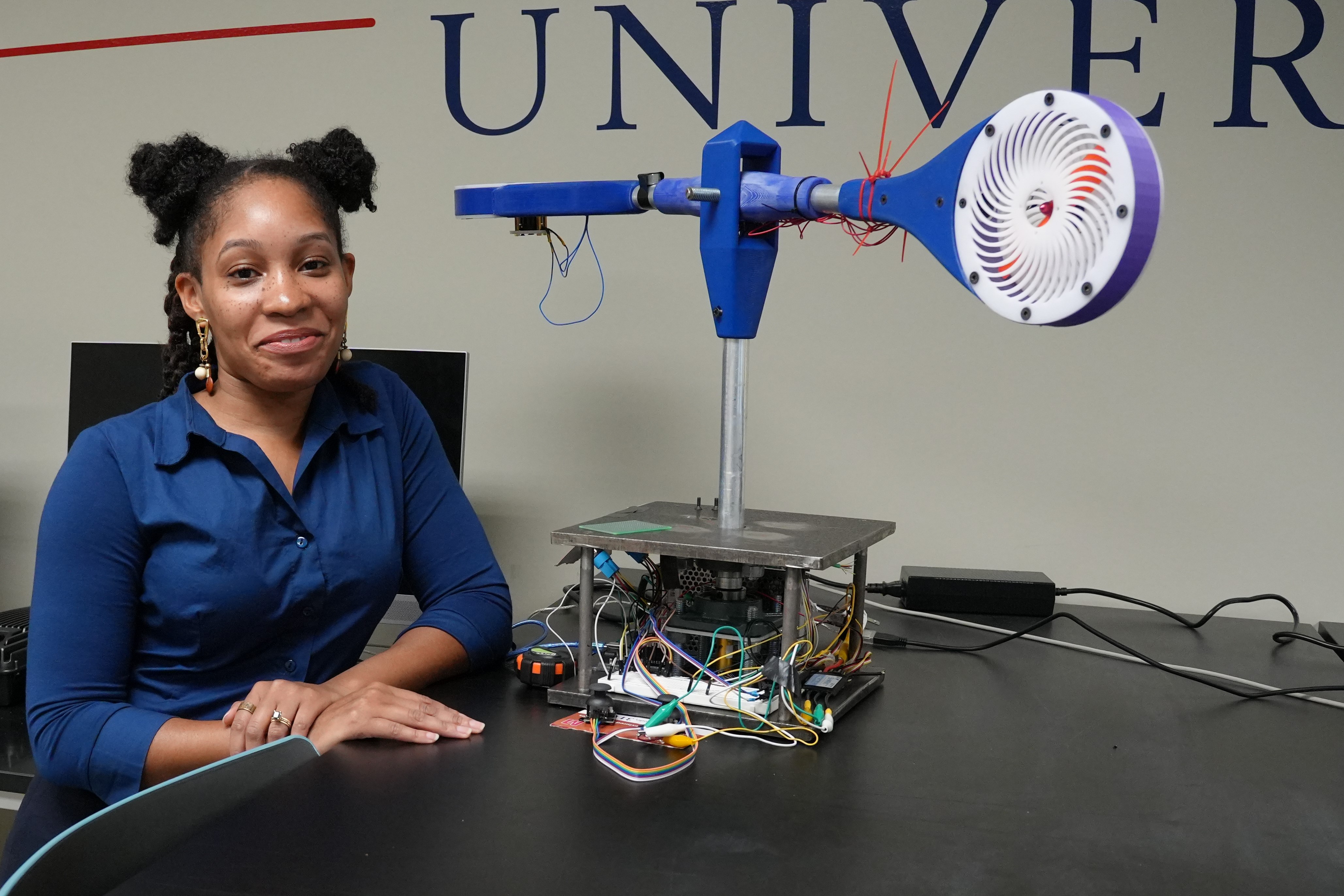 Skyler Dexter in robotics engineering lab with robot project