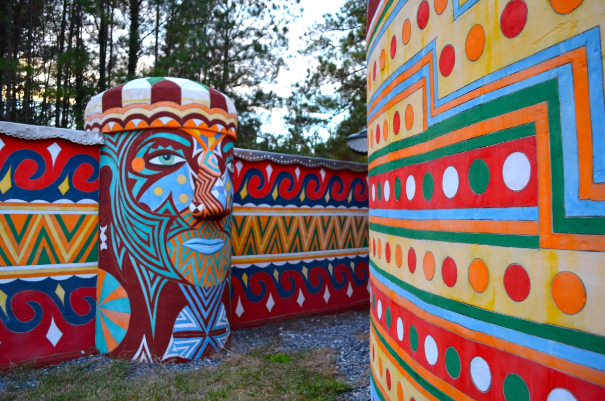 One of the painted concrete walls at Pasaquan, which includes a painted face sculpture