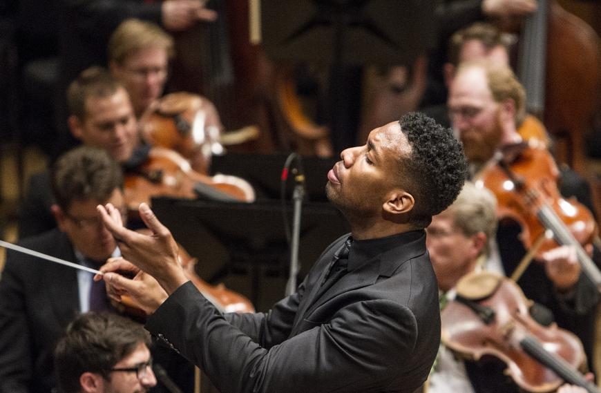 photo of Cox conducting; Credit: Courtney Perry 