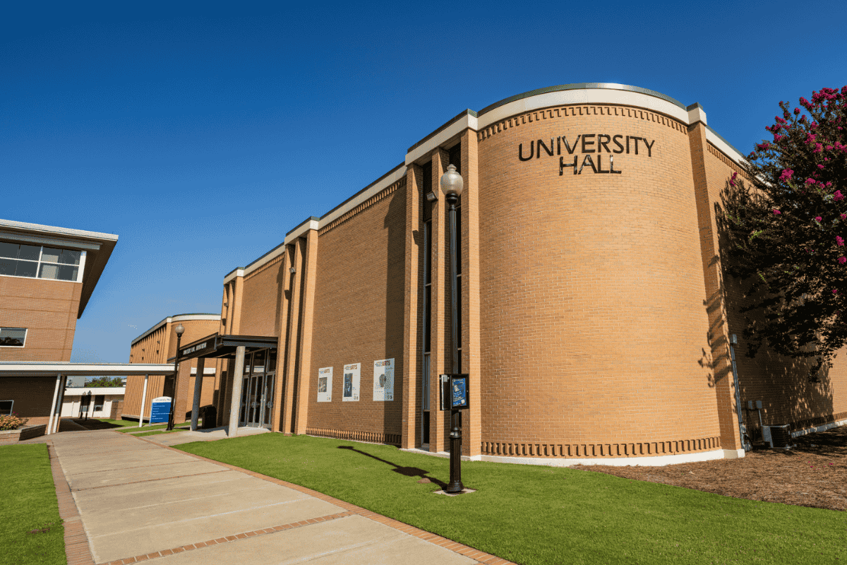 Exterior photo of University Hall with signage that reads 